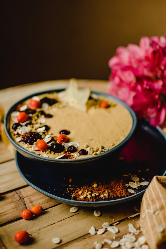 services-01 A wholesome breakfast bowl filled with grains, berries, seeds, and a touch of floral decor.